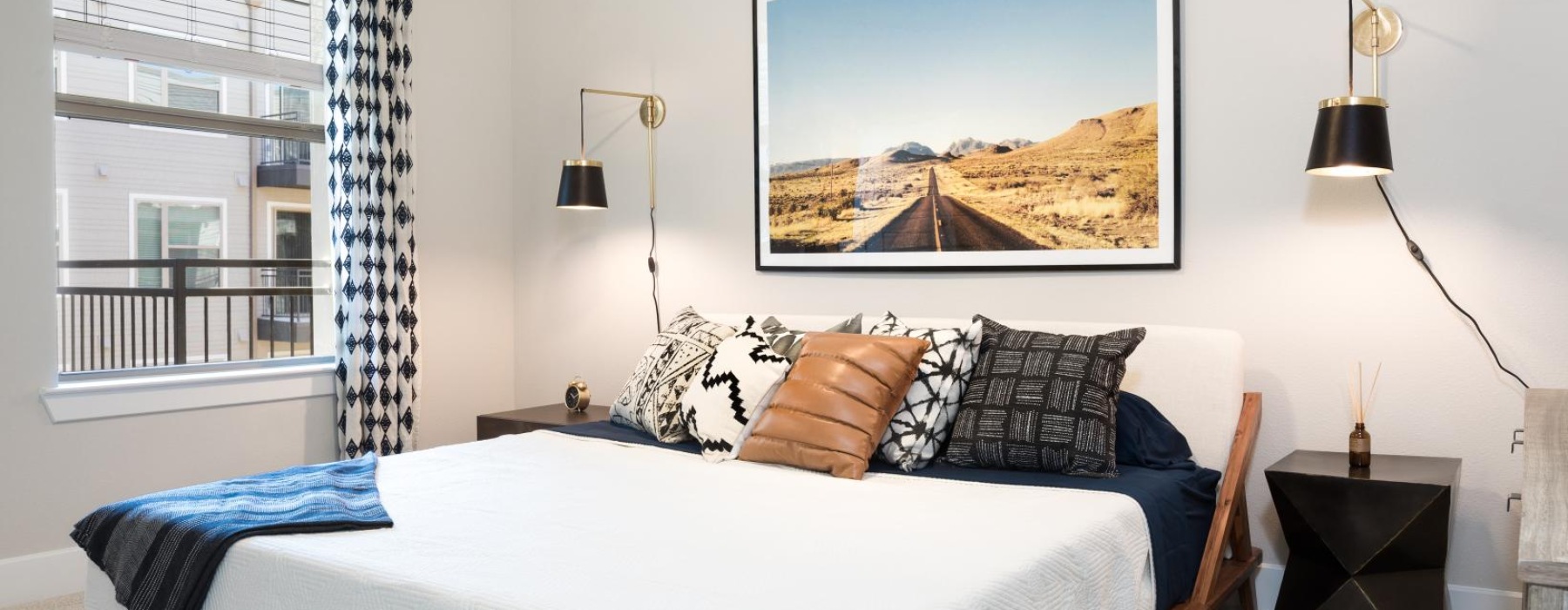 a bedroom with a large painting on the wall