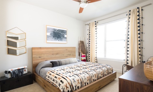 a bedroom with a bed and a dresser