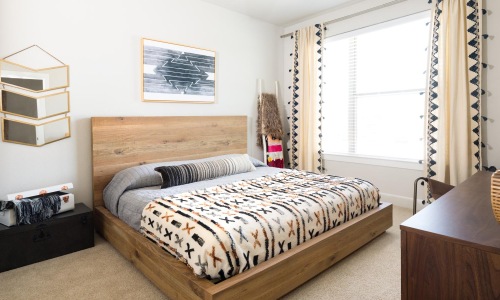 a bedroom with a bed and a fan
